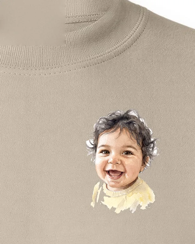 Watercolour portrait of a smiling baby printed on the left chest of a sand crewneck sweatshirt, made from the photo shown in the corner