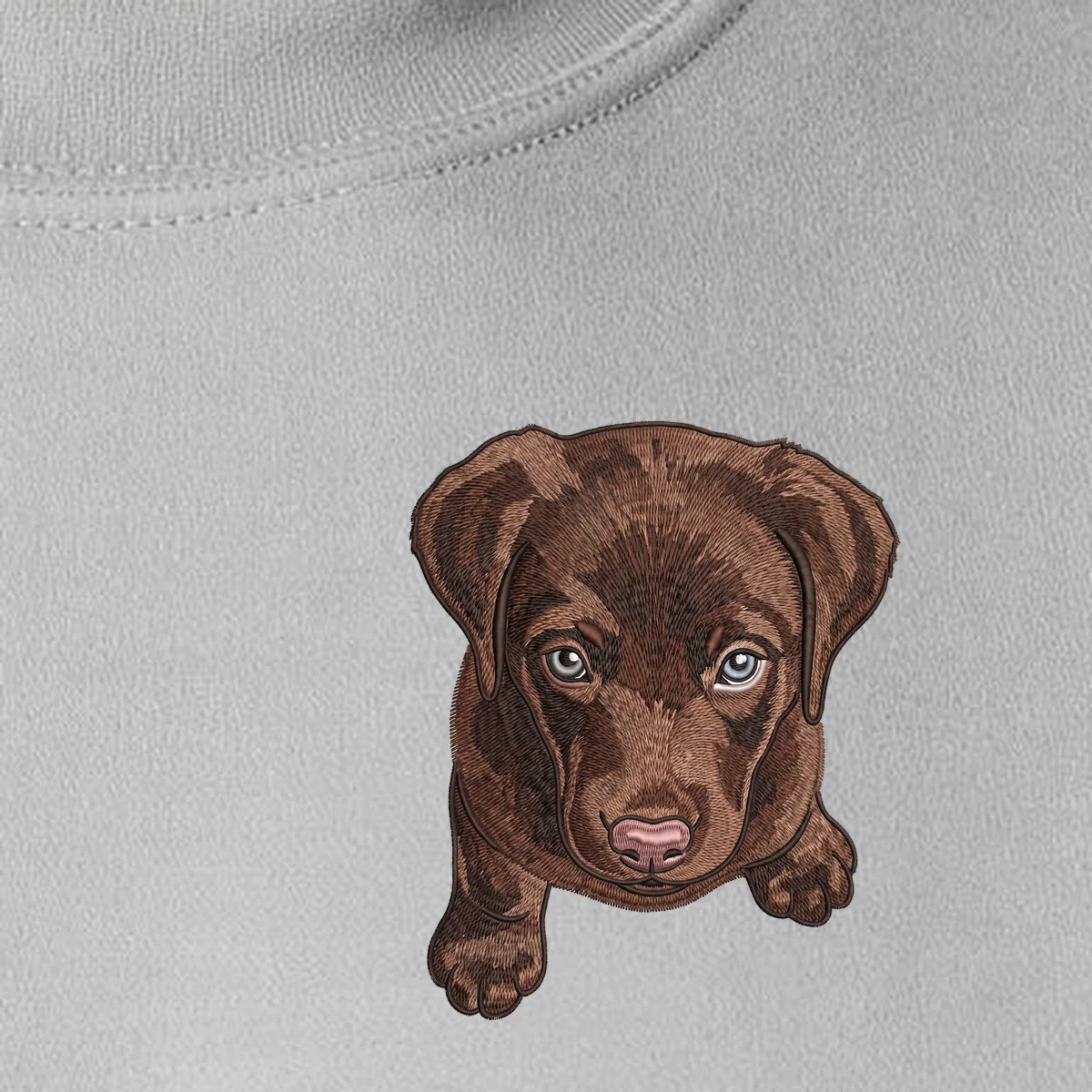 Stitched-look portrait of a chocolate Lab puppy printed on the left chest of an ash crewneck sweatshirt